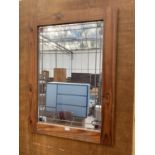 A PINE FRAMED WALL MIRROR WITH LEADED DETAIL
