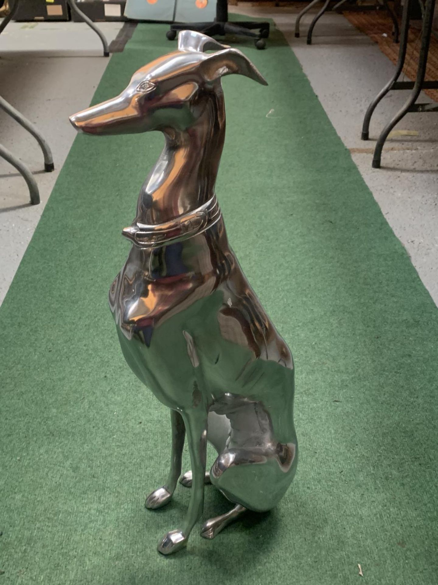 A LARGE CHROME GREYHOUND IN A SITTING POSITION 70CM HIGH