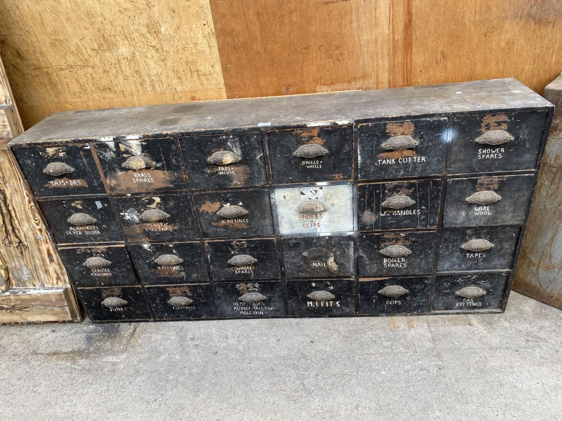 A VINTAGE TWENTY FOUR DRAWER HABERDASHERY CABINET WITH SCOOP HANDLES