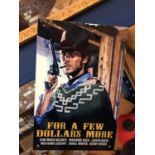 A METAL 'FOR A FEW DOLLARS MORE' CLINT EASTWOOD SIGN