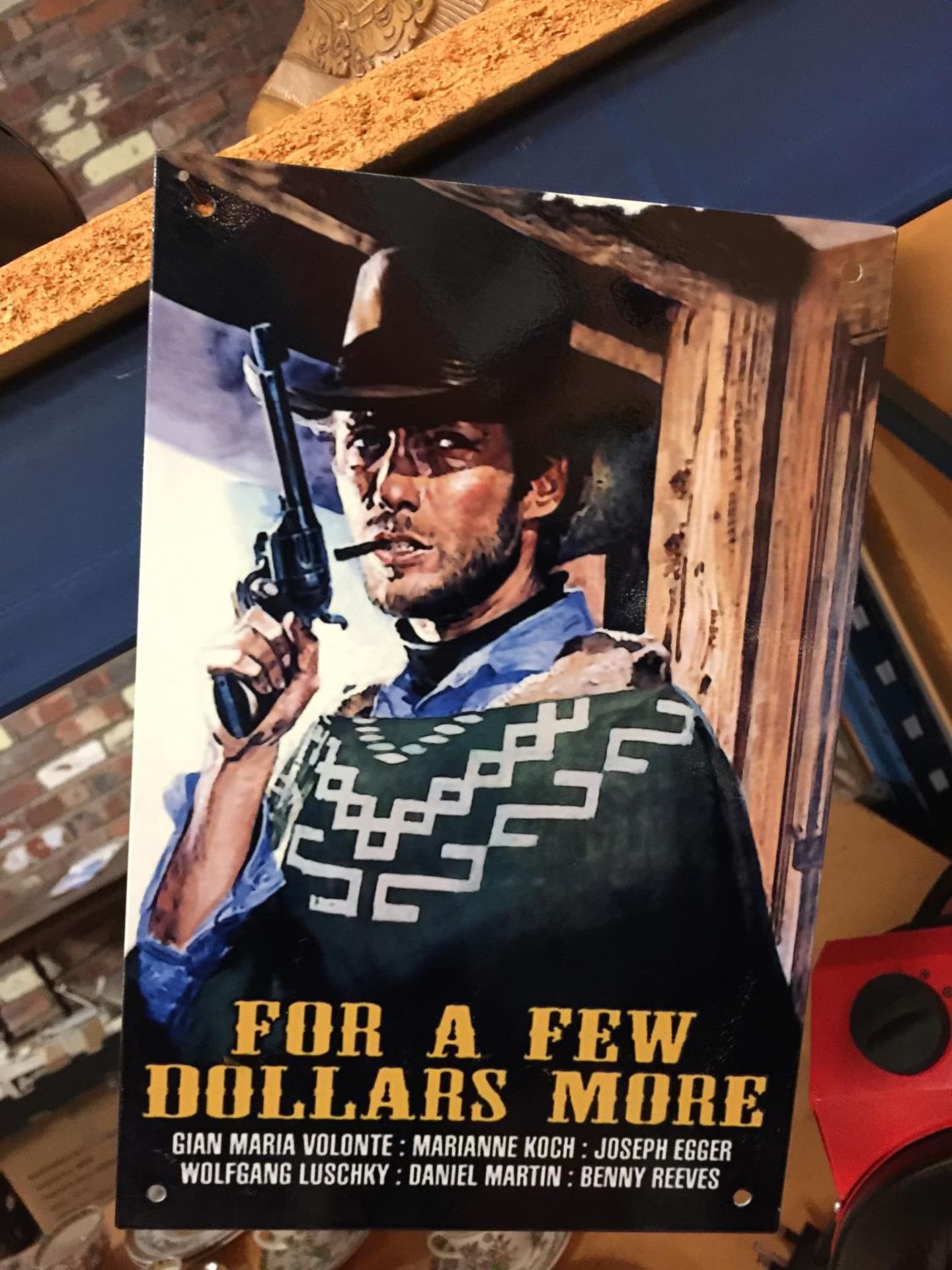 A METAL 'FOR A FEW DOLLARS MORE' CLINT EASTWOOD SIGN