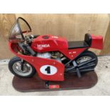 A HONDA RC166 250CC 1965 ORIGINAL FAIRGROUND RIDE ON WOODEN BASE