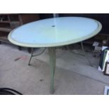 A GLASS TOPPED METAL FRAMED GARDEN TABLE