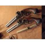 A PAIR OF REPRODUCTION FLINTLOCK PISTOLS AND A KNIFE IN AN ORNATE SHEATH