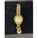 AN ACCURIST 21 JEWELS WRIST WATCH WITH A HALLMARKED 9 CARAT GOLD CASE ON A ROLLED GOLD STRAP NO