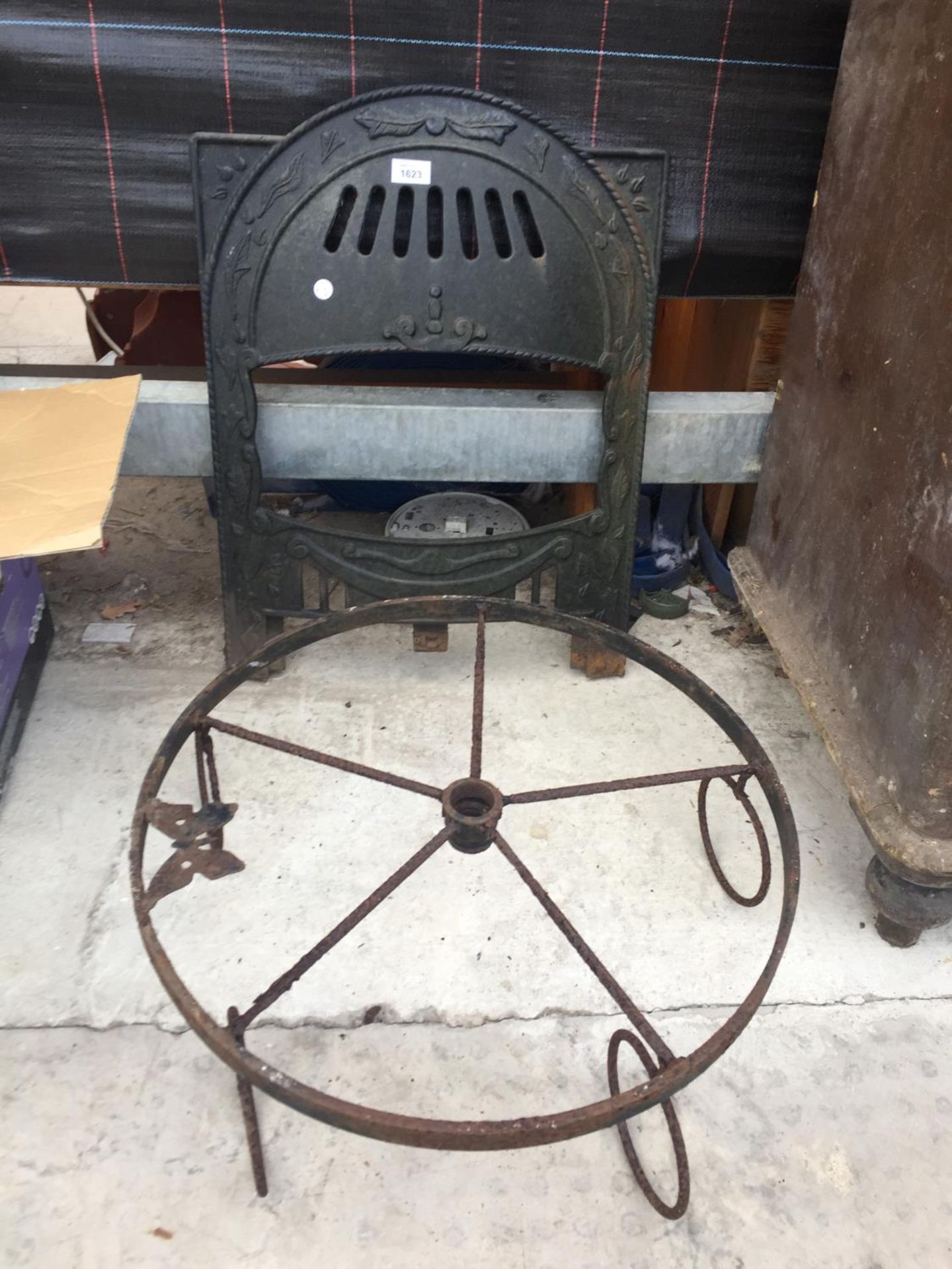 A VINTAGE CAST IRON FIRE FRONT AND A CAST IRON HANGING FRAME