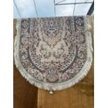 AN OVAL CREAM PATTERNED RUG