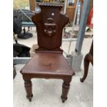 A VICTORIAN MAHOGANY HALL CHAIR WITH CRESTED BACK, ON TURNED FRONT LEGS