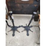 A PAIR OF CAST IRON BAR TABLE BASES