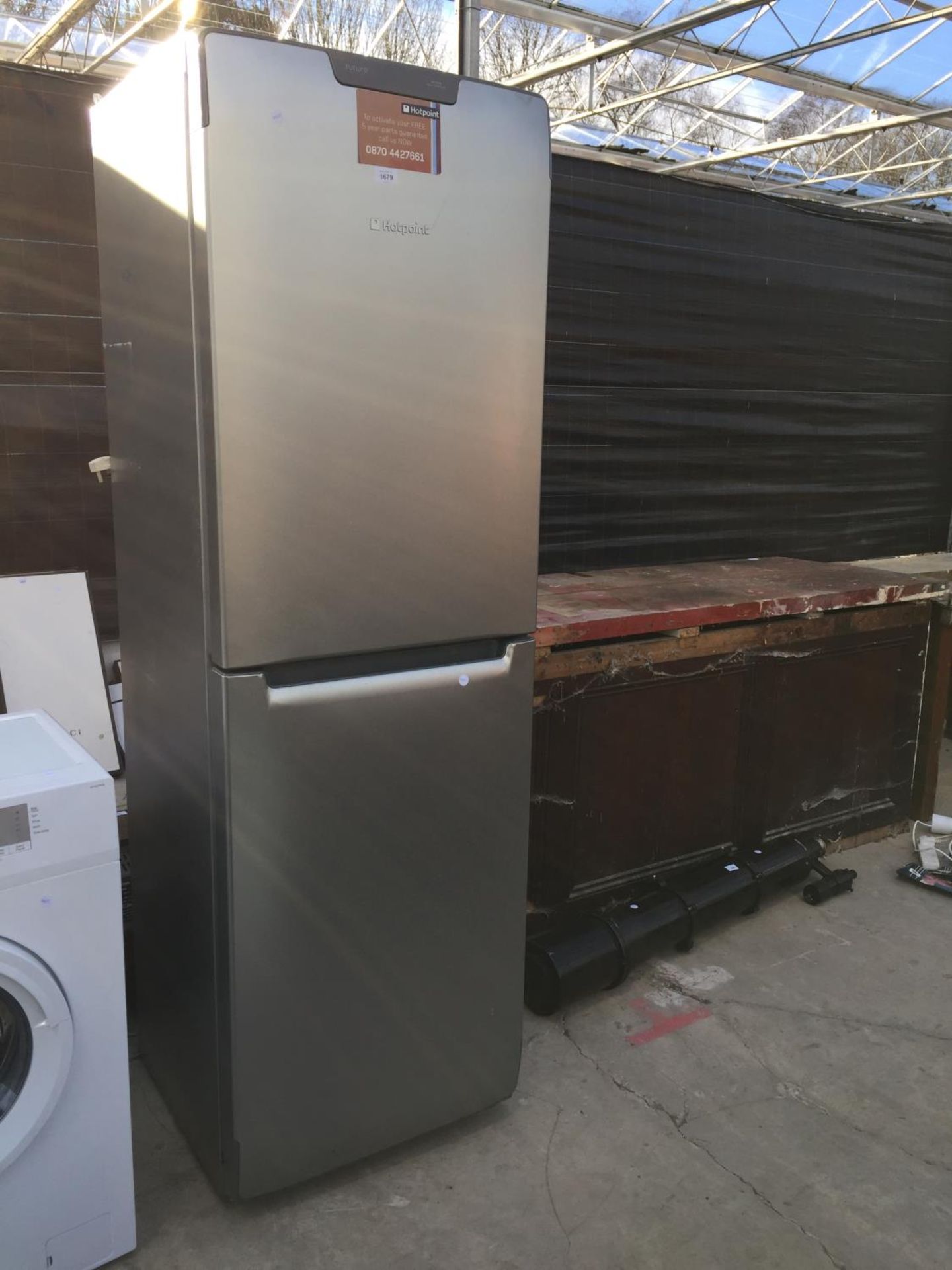 A SILVER HOTPOINT UPRIGHT FRIDGE FREEZER