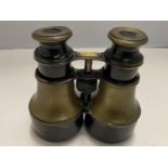 A VINTAGE PAIR OF BLACK AND BRASS BINOCULARS WITH THE NAME W GREGORY, 31 STRAND, LONDON