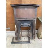 A VINTAGE CAST FIRE PLACE WITH WOODEN SURROUND AND COPPER FIRE FENDER