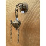 A SMALL DECORATIVE COPPER WALL HANGING BRACKET