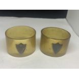 A PAIR OF HORN NAPKIN RINGS WITH A SHIELD MARKED W.D & Co STG