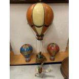 A MODEL HOT AIR BALLOON, TWO MONEY BOXES ANDS A DECORATIVE CAMEL ORNAMENT