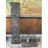 A WROUGHT IRON LOG RACK AND A CAST BENCH BACK