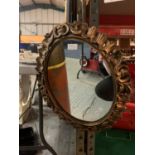 AN OVAL GILT FRAMED MIRROR