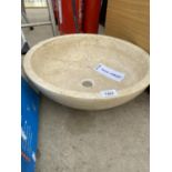 A CREAM WASH BASIN FORMED FROM A PIECE OF MARBLE