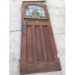 AN EARLY 20TH CENTURY COLOURED GLASS AND LEADED OAK DOOR WITH ARTS & CRAFTS STYLE COPPER PUSH