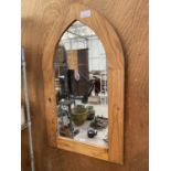 A PINE FRAMED WALL MIRROR WITH CURVED TOP