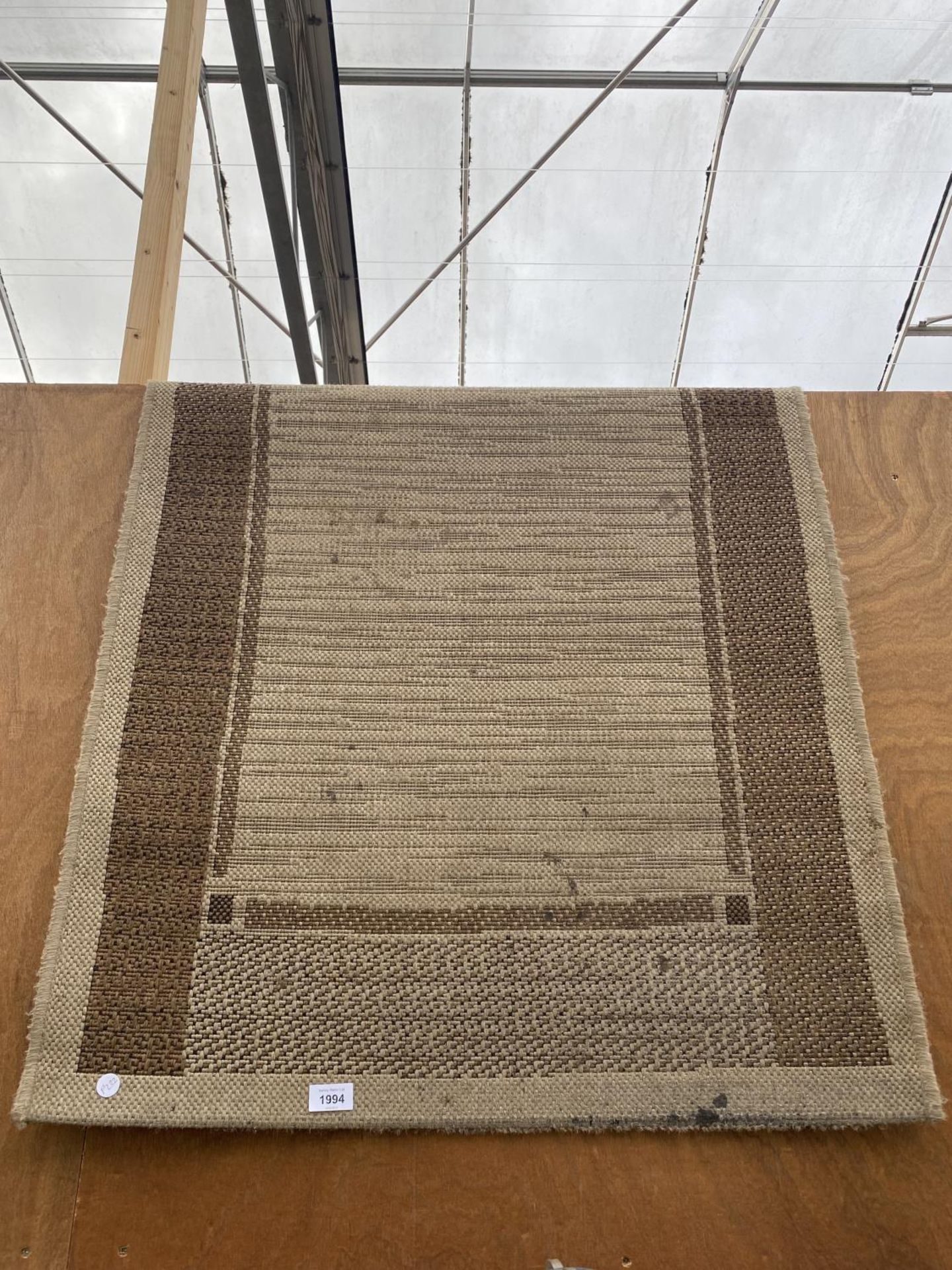 A MODERN CREAM WOVEN RUG