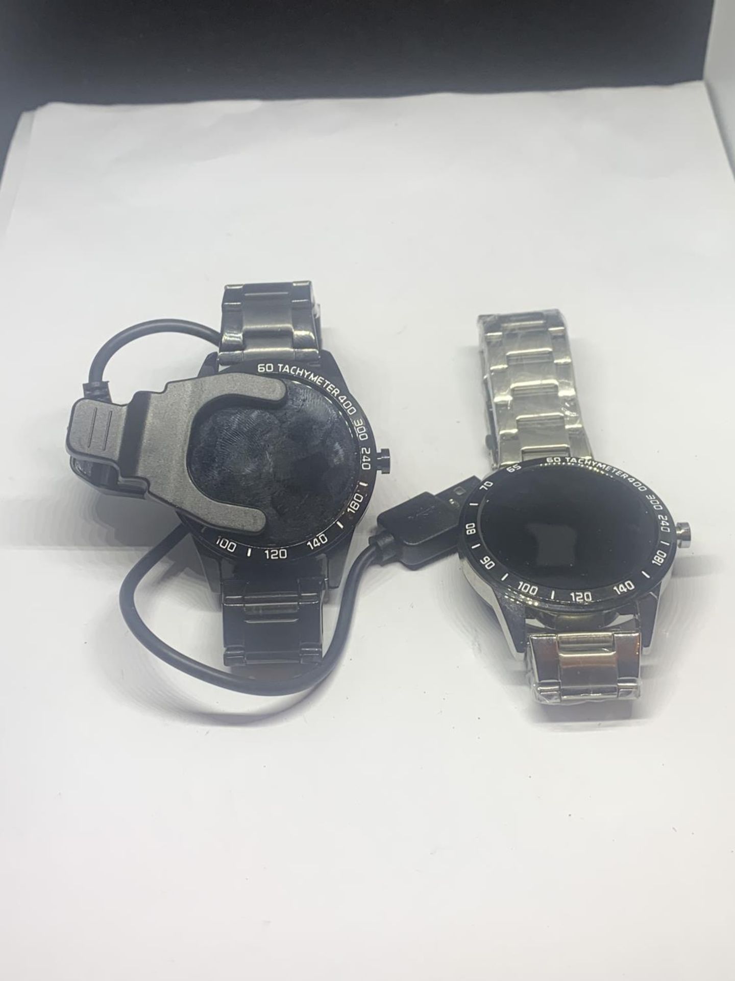 TWO WRIST WATCHES TACHYMETER 400 HEART RATE SMART BRACELET ONE WITH A USB LEAD