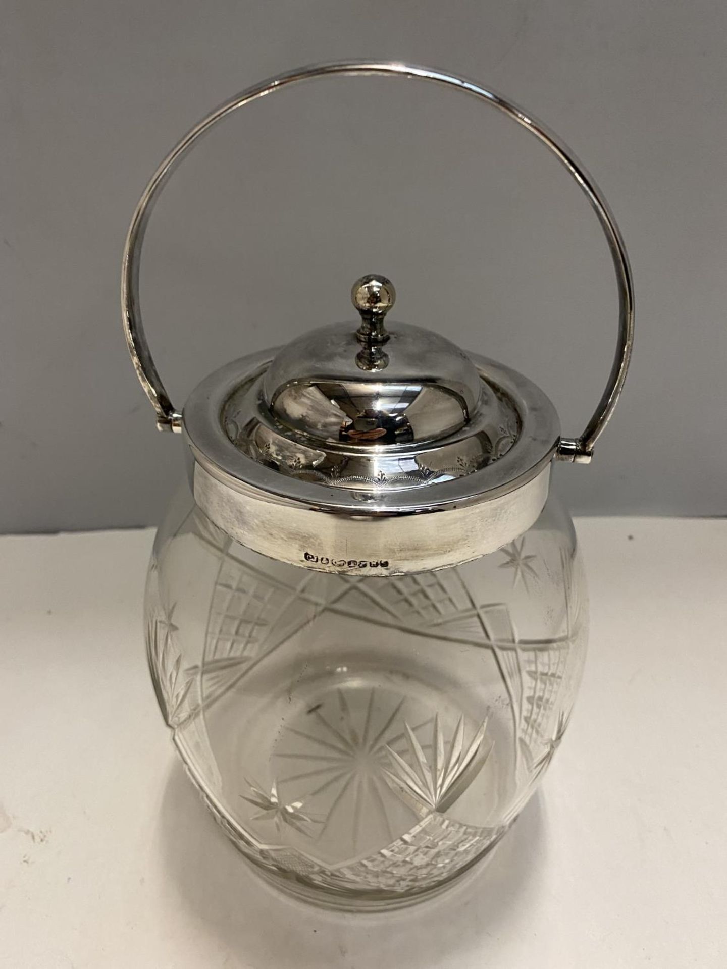 A SILVER PLATED CUT GLASS BISCUIT BARREL