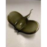 AN OLIVE GREEN COLOURED GLASS PAPERWEIGHT IN THE SHAPE OF A STING RAY