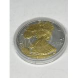 A SILVER 2004 1OZ AMERICAN ONE DOLLAR COIN WITH A GILDED LIBERTY EAGLE DECORATION -CAPSULATED