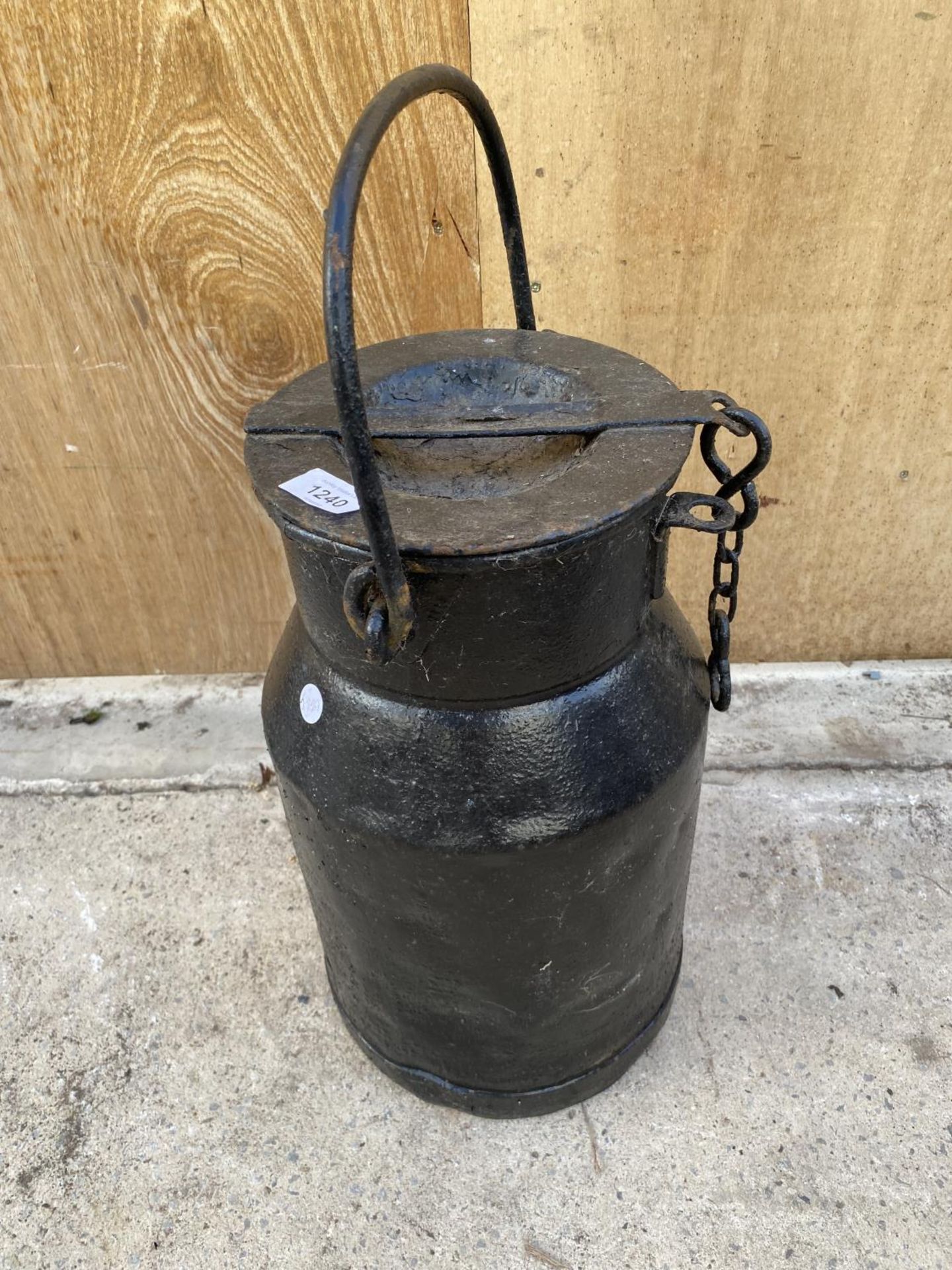 A VINTAGE CAST IRON MILK CHURN