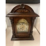 A MAHOGANY WESTMINSTER CHIMING BRACKET CLOCK WITH A DECORATIVE GILDED FACE AND KEY