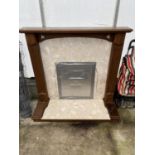 A WOODEN AND MARBLE EFFECT FIRE SURROUND