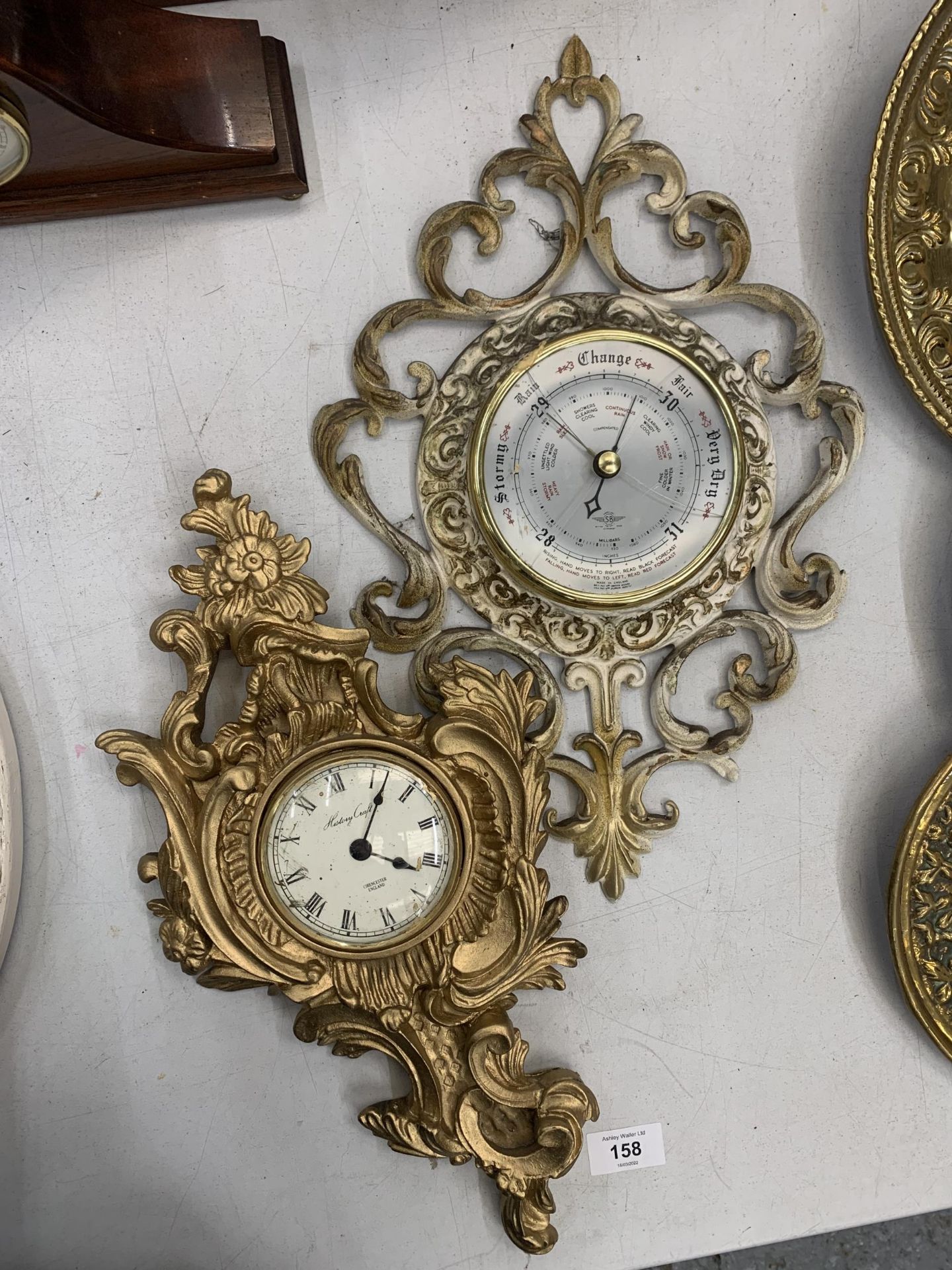 AN ORNATE STYLE RESIN BAROMETER AND A WALL CLOCK
