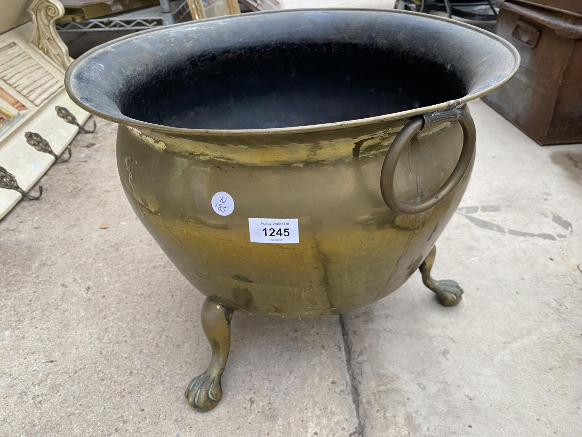 A LARGE VINTAGE BRASS COAL BUCKET ON LION PAW FEET