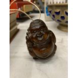 A WOODEN CARVED BUDDHA