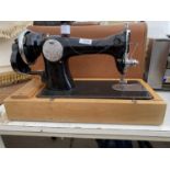 A VINTAGE MANUAL SEWING MACHINE WITH CARRY CASE