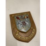 A WOODEN MILITARY SHIELD SIGNED TO THE BACK WITH A VARIETY OF SIGNATURES 15CM X 19CM