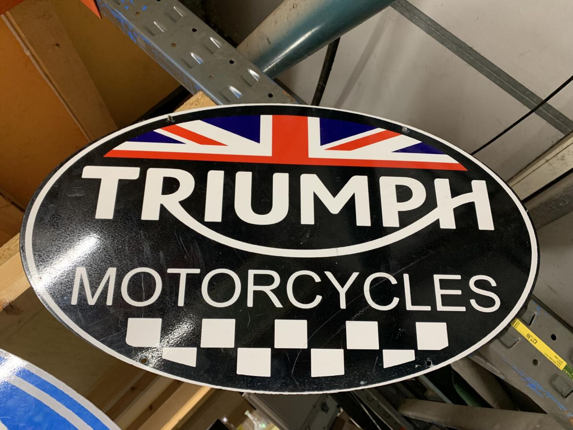 A TRIUMPH MOTORCYCLE METAL SIGN