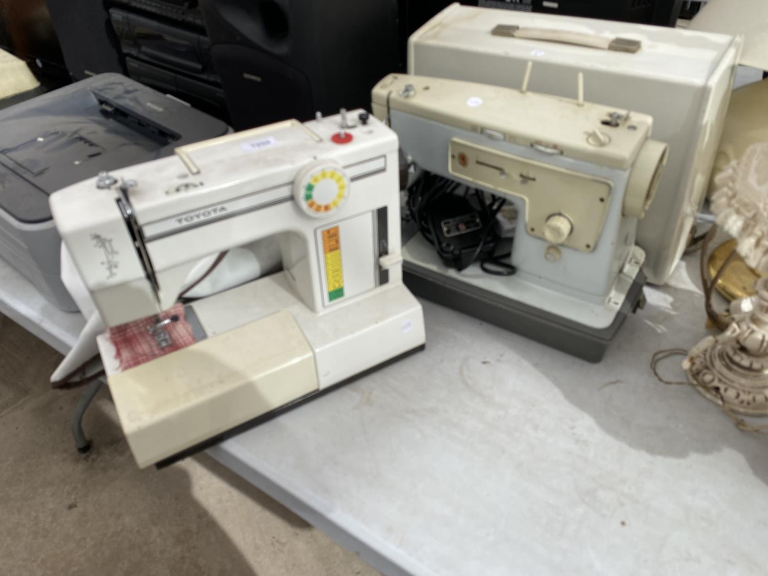A RETRO TOYOTA SEWING MACHINE AND FURTHER RETRO SINGER SEWING MACHINE WITH FOOT PEDAL