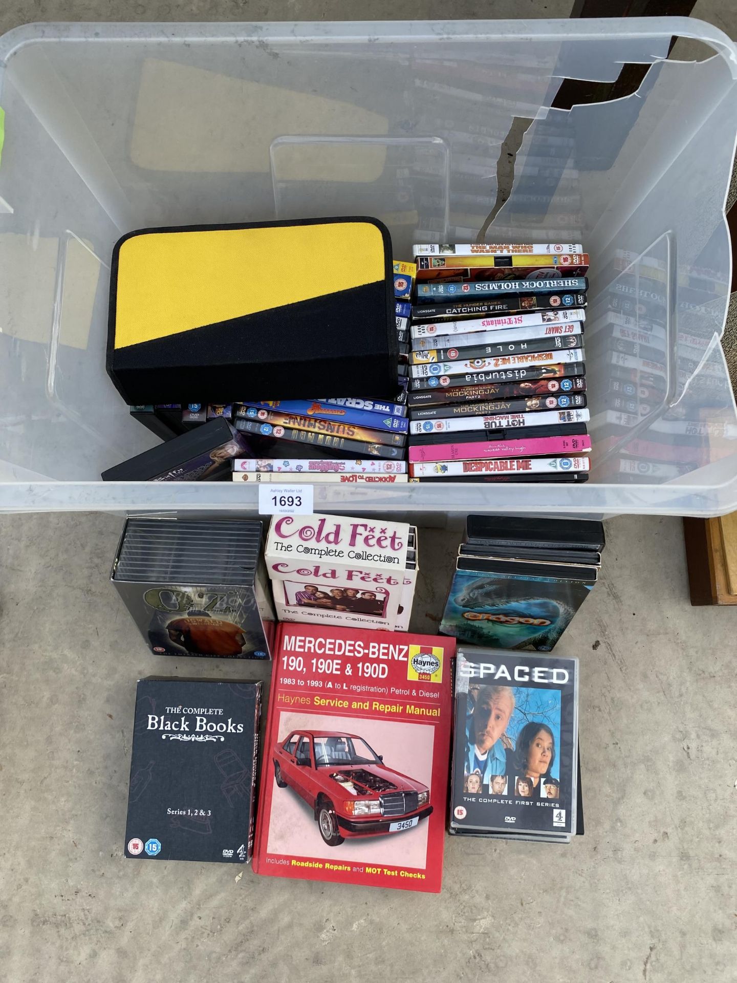 AN ASSORTMENT OF DVDS AND A HAYNES MANUAL