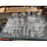 A LARGE ASSORTMENT OF GLASS WARE TO INCLUDE VASES, WINE GLASSES AND SHERRY GLASSES ETC