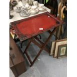 A BUTLERS TRAY ON A FOLDING STAND HEIGHT 75CM