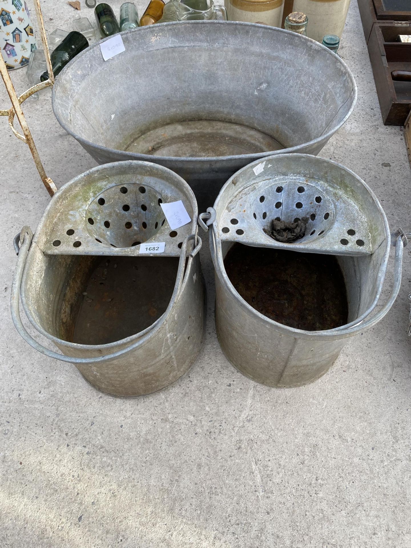 TWO VINTAGE GALVANISED MOP BUCKETS AND A GALVANISED TIN BATH