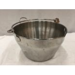 A LARGE STAINLESS STEEL COOKING POT