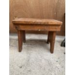 A SMALL OAK MILKING STOOL