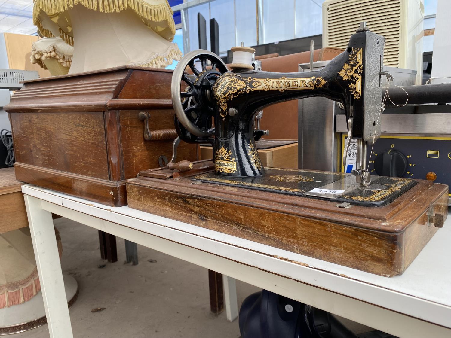 A VINTAGE SINGER SEWING MACHINE WITH WOODEN CARRY CASE