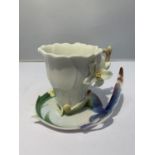 A BAYMARK AUSTRALIA GARDEN THEMED TEACUP AND SAUCER