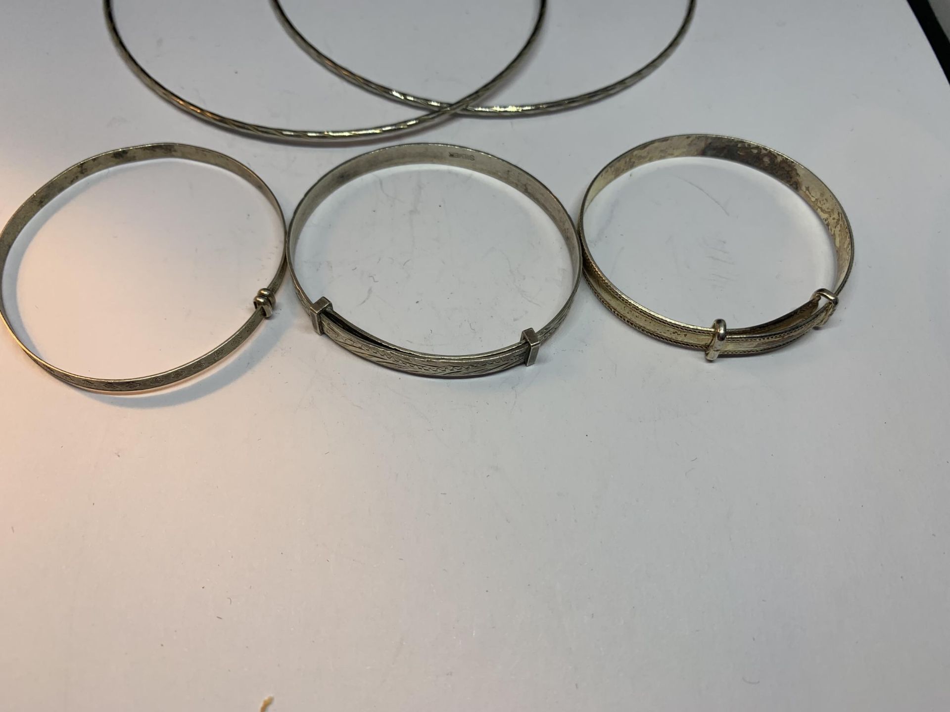 THREE SILVER CHILDRENS BANGLES AND A PAIR OF LARGE EARRINGS - Image 2 of 3