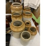 A COLLECTION OF EIGHT STONEWARE POTS