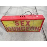 AN ILLUMINATED 'SEX DUNGEON' SIGN A/F